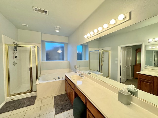 bathroom featuring tile patterned flooring, vanity, and plus walk in shower