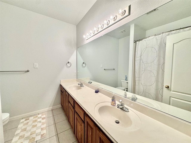 bathroom featuring tile patterned flooring, vanity, and toilet