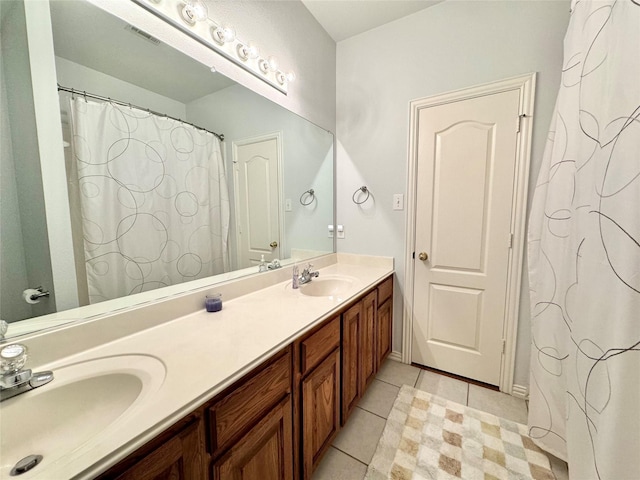 bathroom featuring tile patterned flooring and vanity