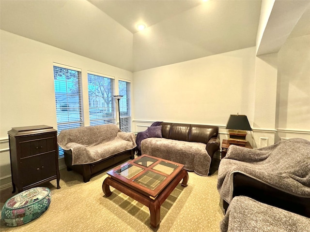 carpeted living room featuring lofted ceiling