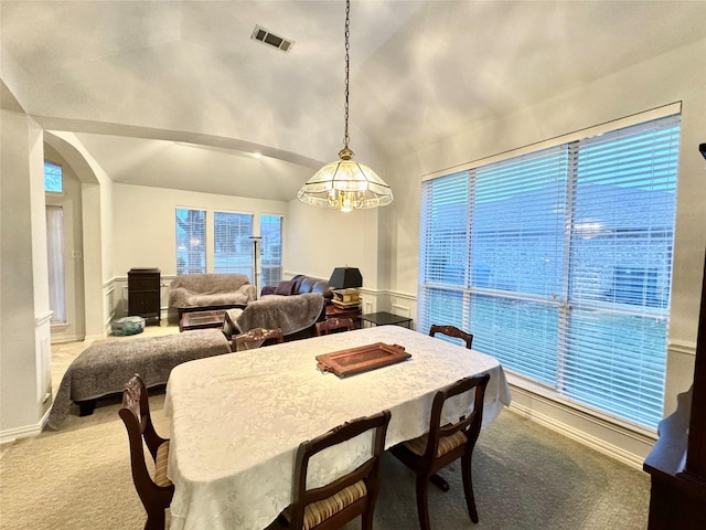 dining area with carpet, a wealth of natural light, and lofted ceiling