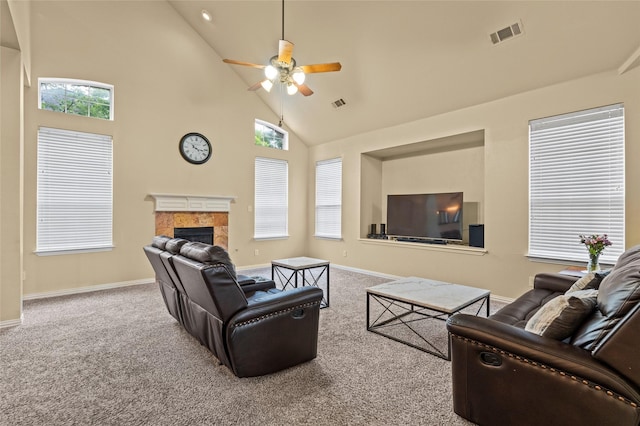 carpeted living room with high vaulted ceiling, ceiling fan, and a fireplace