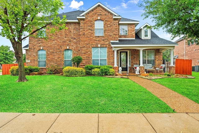 view of front facade featuring a front yard and covered porch