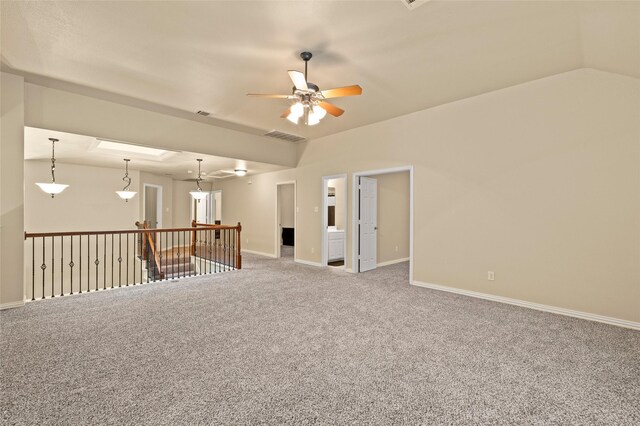 unfurnished room with ceiling fan, carpet, and lofted ceiling with skylight