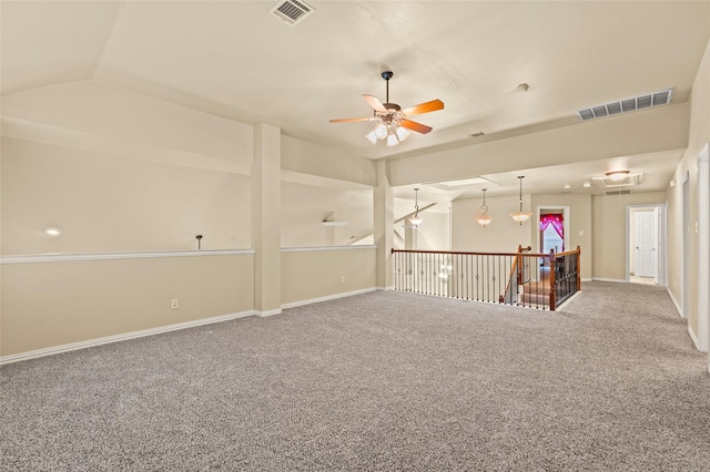 spare room with ceiling fan, lofted ceiling, and carpet flooring