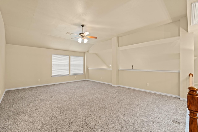 empty room featuring ceiling fan, carpet, and vaulted ceiling