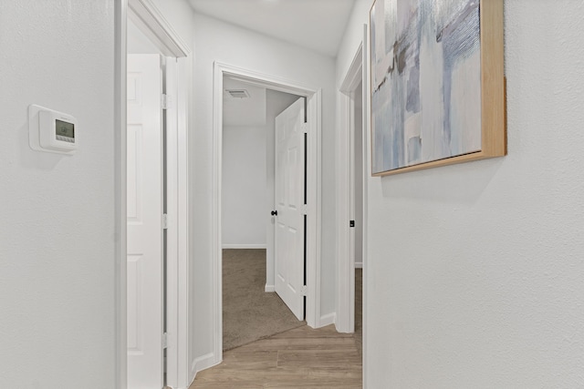 corridor with light wood-type flooring