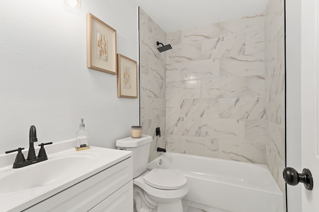 full bathroom featuring tiled shower / bath combo, toilet, and vanity