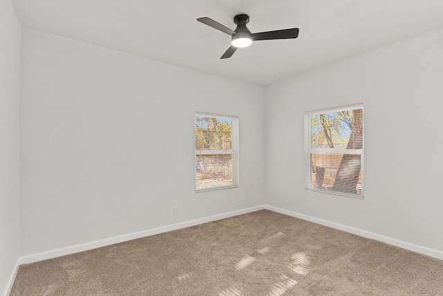 spare room with carpet and ceiling fan