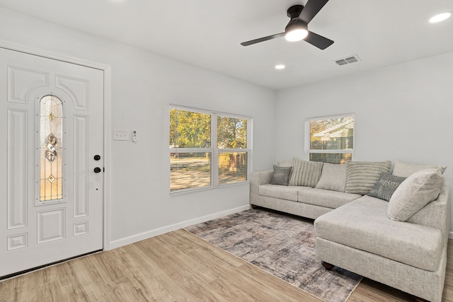 living room with ceiling fan and hardwood / wood-style flooring