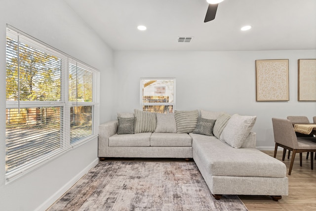 living room featuring hardwood / wood-style floors and ceiling fan