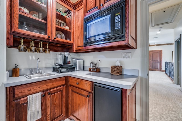 kitchen featuring sink, black microwave, light carpet, and stainless steel refrigerator