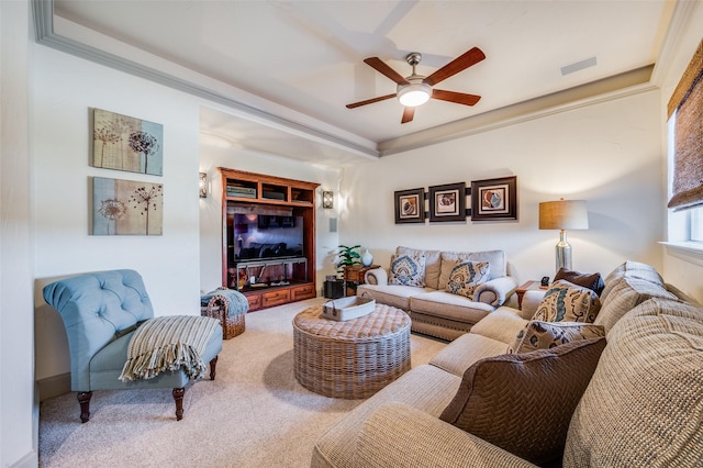 carpeted living room featuring ceiling fan and ornamental molding