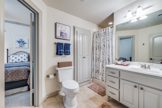 bathroom featuring vanity, tile patterned floors, a shower with shower curtain, toilet, and a textured ceiling