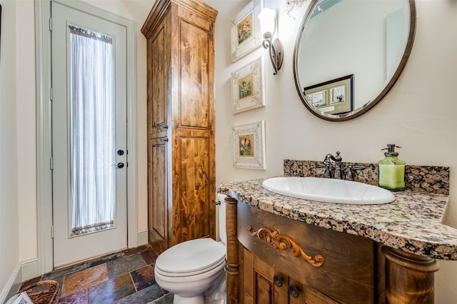 117 Woodland Dr, Krugerville, TX 76227 - bathroom featuring stone tile flooring, toilet, and vanity
