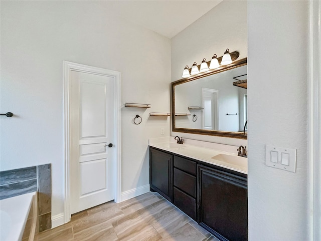 bathroom featuring a tub, vanity, and wood-type flooring