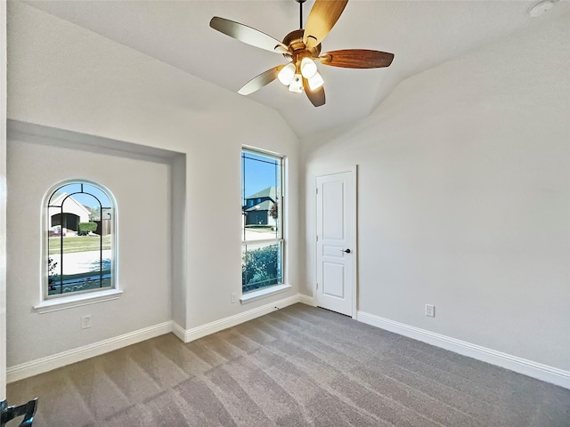 unfurnished room featuring light carpet, a wealth of natural light, and lofted ceiling