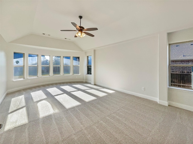 empty room with ceiling fan, light colored carpet, and lofted ceiling