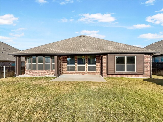 rear view of house with a patio area and a yard