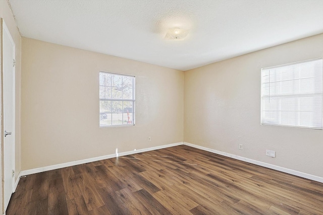 unfurnished room featuring dark hardwood / wood-style flooring