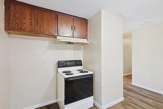 kitchen with a textured ceiling, light hardwood / wood-style flooring, and white electric stove