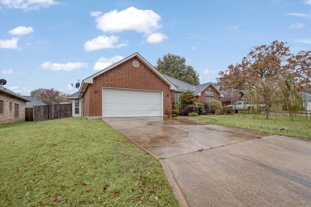 view of front of home featuring driveway, fence, a front yard, a garage, and brick siding