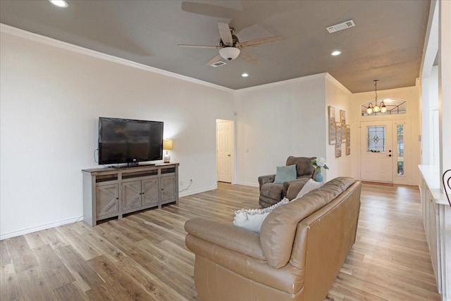 living room featuring ceiling fan with notable chandelier, light wood-type flooring, and ornamental molding