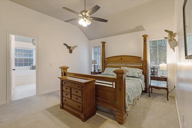 bedroom with connected bathroom, light colored carpet, ceiling fan, and lofted ceiling