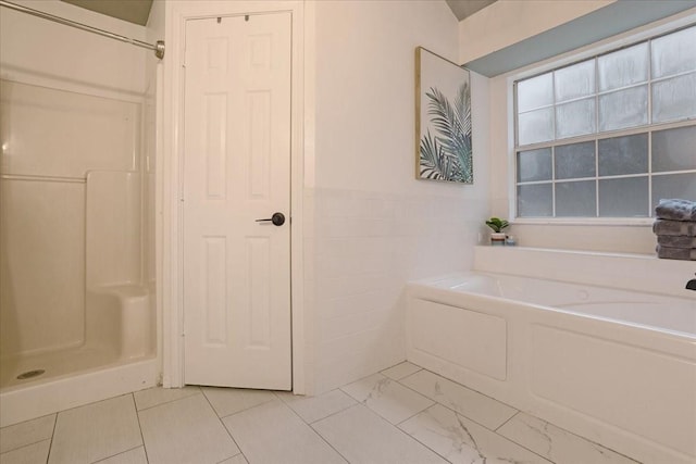 bathroom featuring plus walk in shower