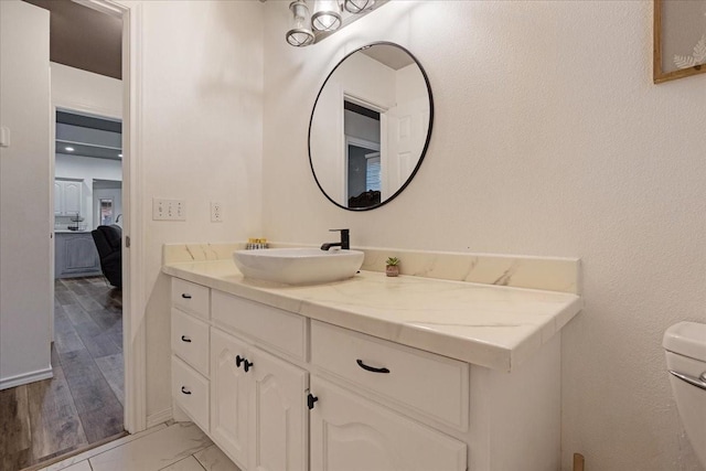 bathroom featuring hardwood / wood-style floors, vanity, and toilet