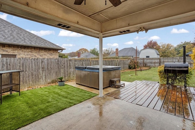 view of patio / terrace with a hot tub and a deck