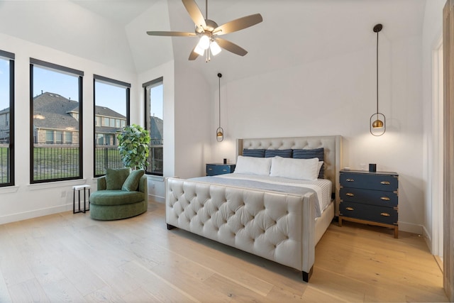 bedroom featuring hardwood / wood-style flooring, ceiling fan, and lofted ceiling