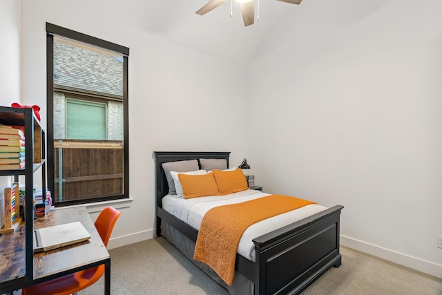 bedroom with ceiling fan, light colored carpet, and vaulted ceiling