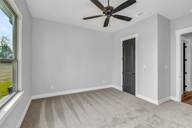 empty room with carpet and ceiling fan