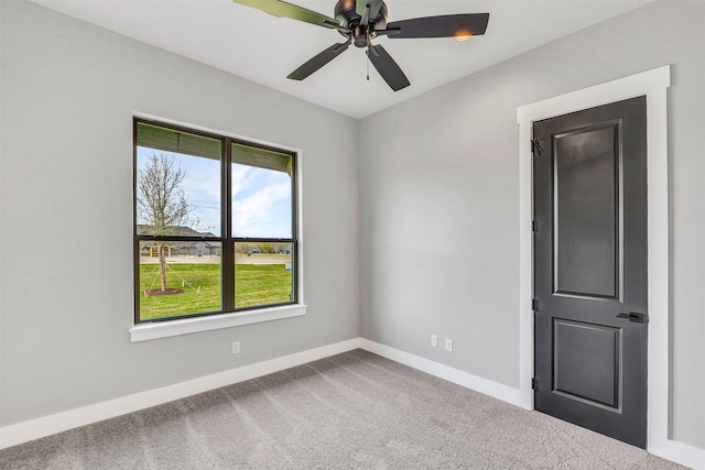 spare room with carpet and ceiling fan