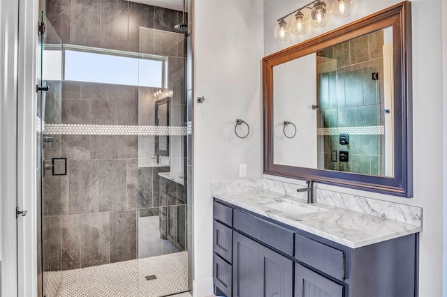 bathroom with vanity and a shower with shower door