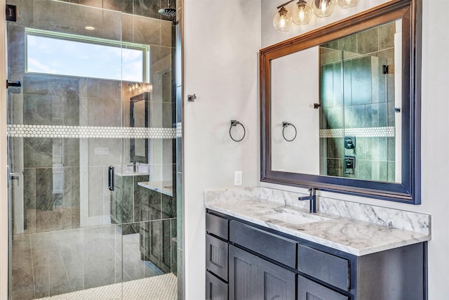 bathroom with vanity and a shower with shower door