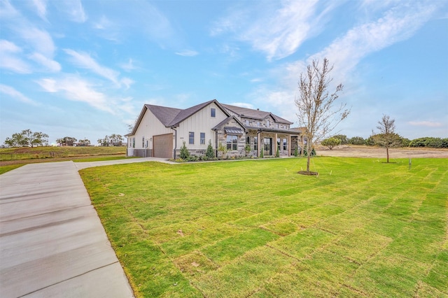 view of front of property with a front lawn and a garage