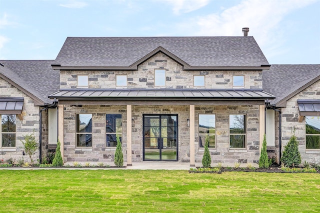 rear view of house featuring a yard