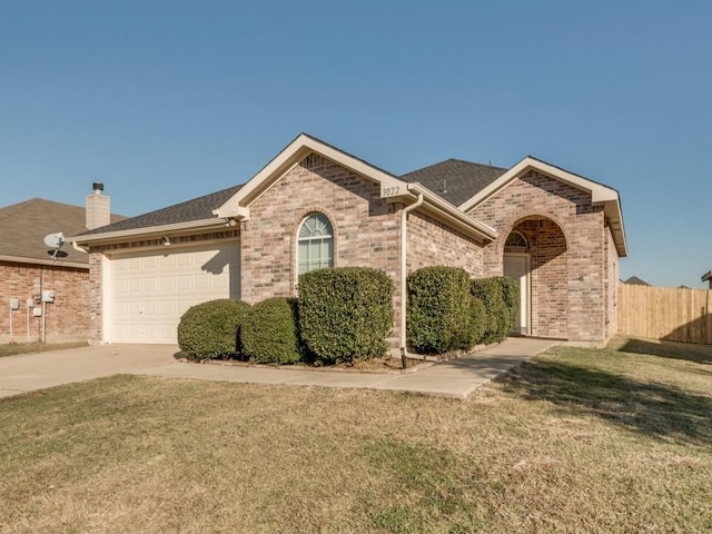 ranch-style home with a front lawn and a garage