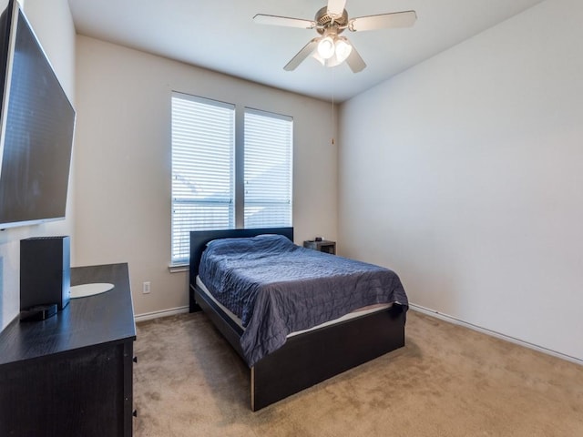 bedroom with ceiling fan and light carpet