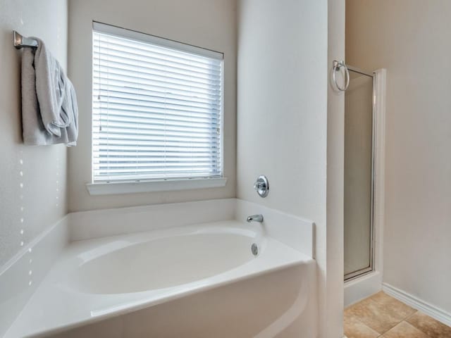 bathroom featuring tile patterned floors and shower with separate bathtub