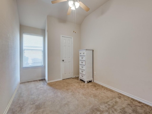 unfurnished bedroom featuring ceiling fan, light colored carpet, and lofted ceiling