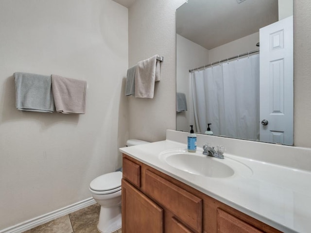 bathroom with tile patterned flooring, vanity, and toilet