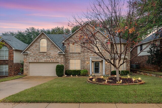 view of front property with a garage and a front lawn