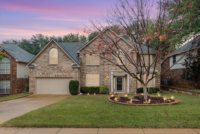 view of property with a garage and a front lawn