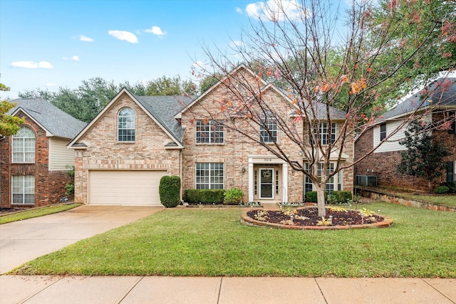 view of property featuring a garage and a front yard