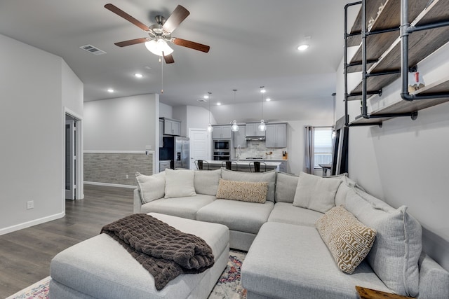 living room with ceiling fan, hardwood / wood-style floors, and lofted ceiling