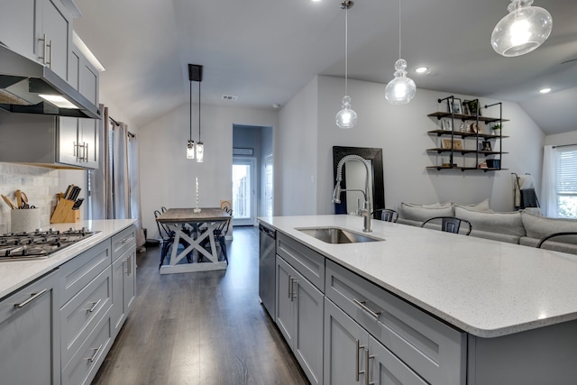 kitchen featuring gray cabinetry, decorative light fixtures, an island with sink, and stainless steel appliances