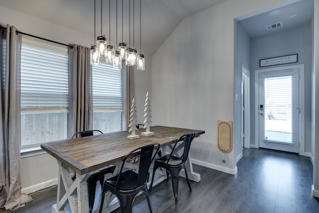 dining area with dark hardwood / wood-style floors and vaulted ceiling